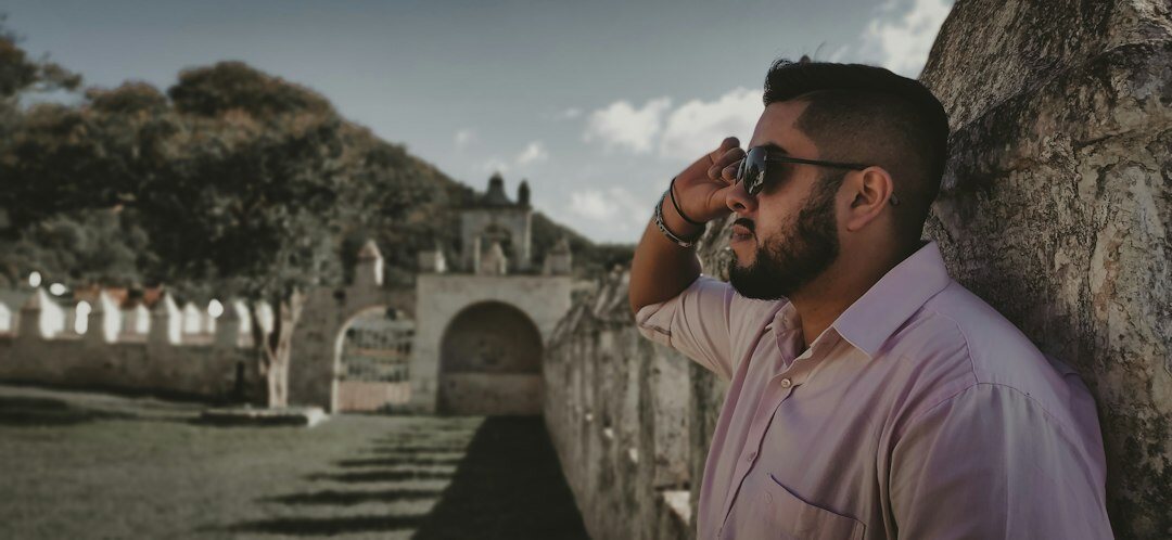 Smiling Mexican male insurance advisor on a phone call