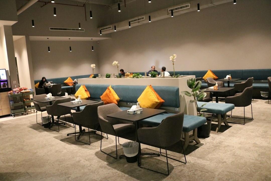 Mexican coworkers having a relaxed conversation in office lounge